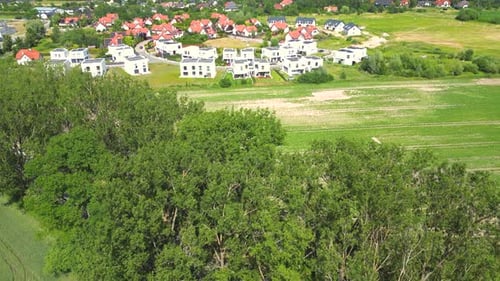 Aerial view of residential houses neighborhood and apartment building complex at sunset. Tightly pac