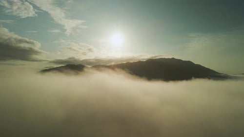 Costa Rica Mountain Peak Surrounded By Clouds With Bright Sun, 4K Aerial Drone