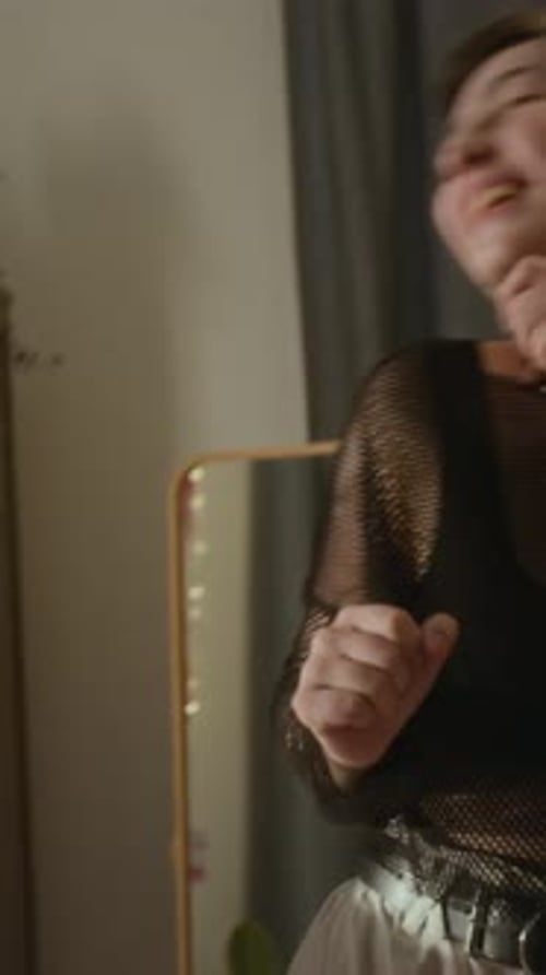 Two Smiling Women Dancing in an Apartment