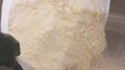 Flour Being Poured into an Industrial Mixing Bowl