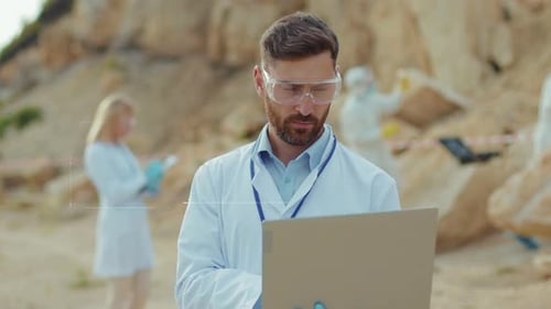 Scientist Using Laptop on Location, Turns to Smile