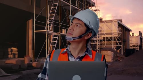 Close Up Of Asian Male Engineer Working On A Laptop At Building Site