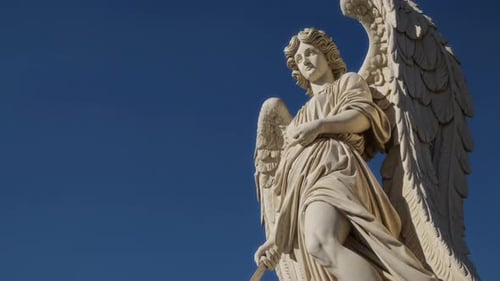 The Majestic Angel Statue Stands Majestically and Beautifully Against the Clear Blue Sky Above