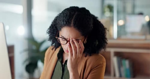 Tired Woman Working at Computer in Modern Office