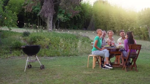 Friends Share Food and Wine at Outdoor Gathering