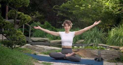 Woman Practicing Yoga Outside in Nature Setting