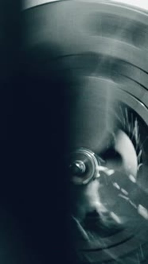 Metalworking lathe in action: skilled worker shaping metal with precision