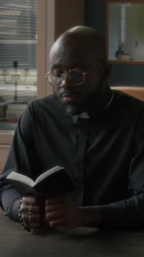 Middle Aged Man Reading Book Indoors