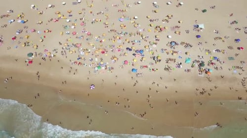 Mediterranean beach during summer with people in the water
