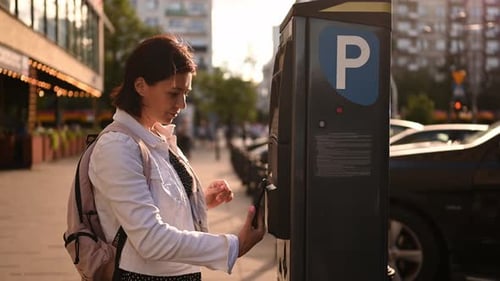 Female Paying For Street Parking On Parking Meter Machine