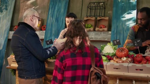 Customer Purchasing Fresh Produce at Urban Farmer's Market