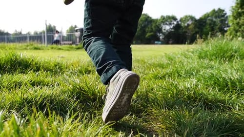 A child walking on a green field