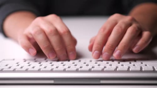 Male Hands Typing on a White Keyboard Work in the Office and at Home