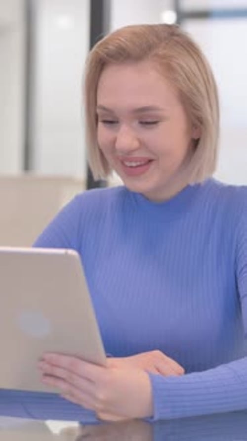 Young Woman Doing Video Chat on Tablet in Office, vertical video