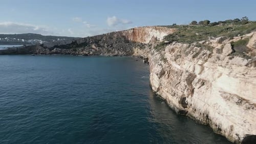 Drone footage over the sea at Malta island, next to a beatiful cliff