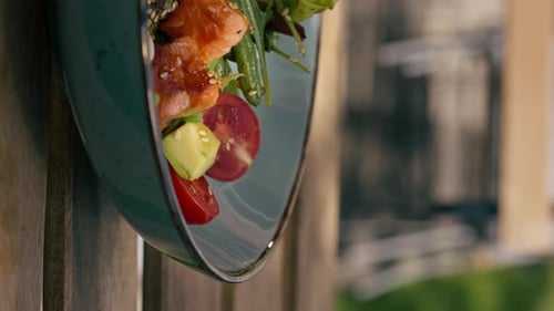 in a Restaurant on the Street on Plank Table a Blue Vertical Video Plate with a Warm Salad with