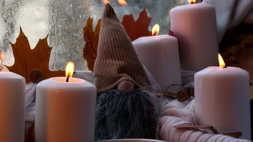 Festive Candles with Gnome Decoration on Windowsill