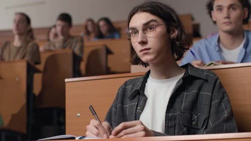 Attentive students engaging in higher education lecture at university classroom