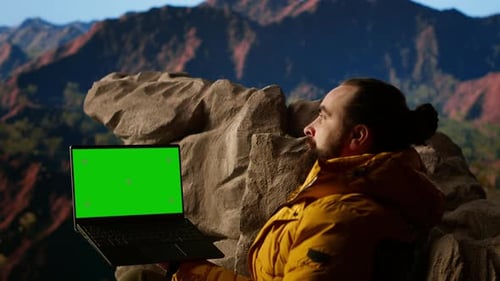 Trekker Takes in the Panoramic Landscape Next to Isolated Mockup Screen