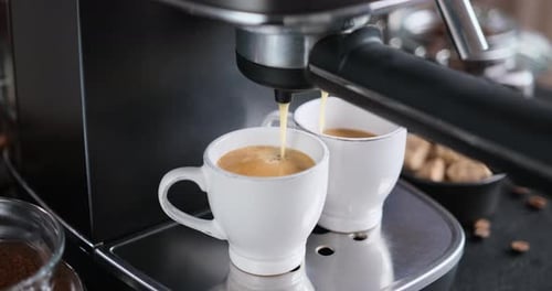 Home Espresso Making Process Coffee Stream Pouring From Machine Into Ceramic Cup