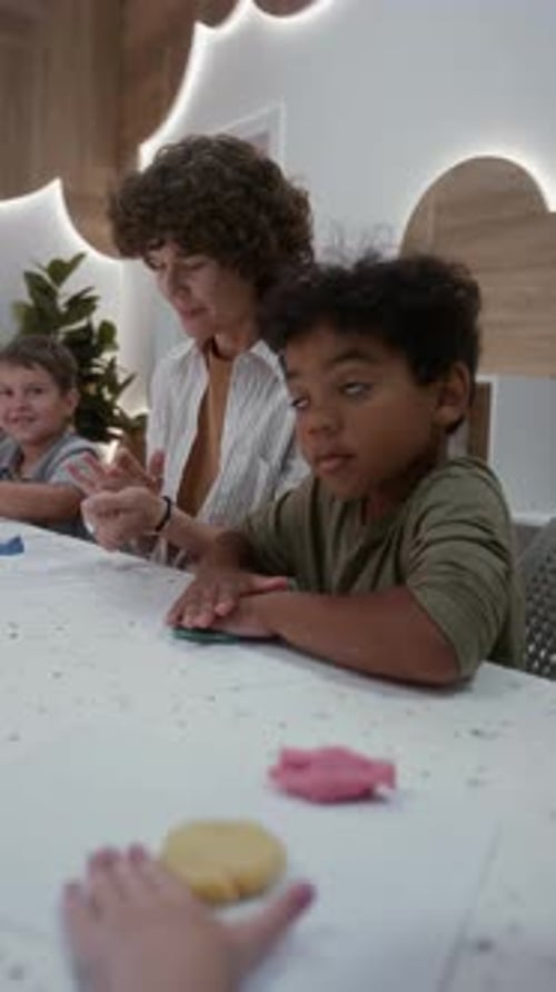 Children Playing With Clay With Teacher