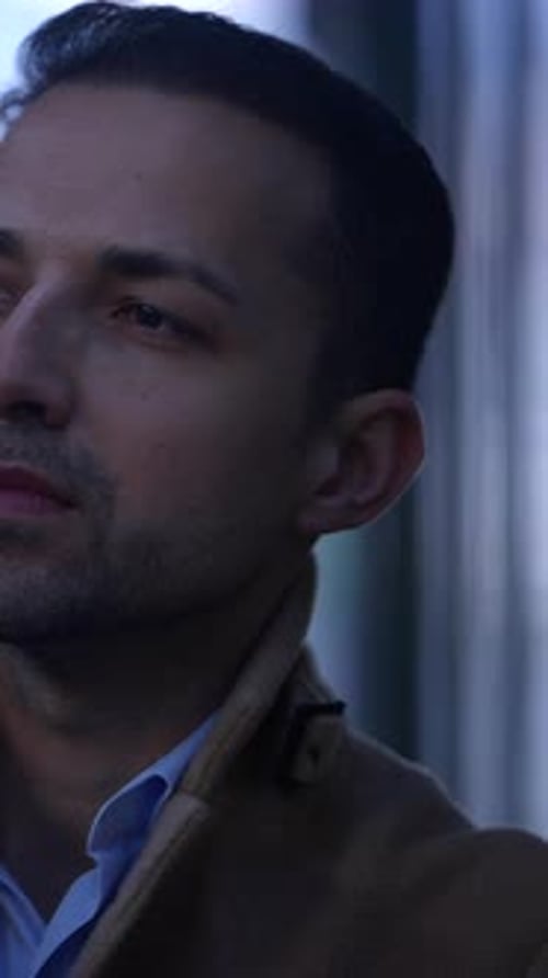 A Thoughtful and Pensive Man Wearing a Classy Coat Reflecting on the Complexities of City Life