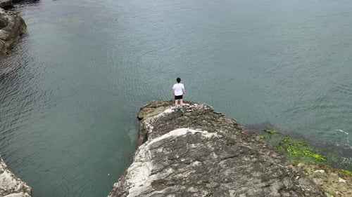 man training on cliff