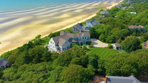 Panoramic Drone Shot of Beachfront Estate with Expansive Sandy Shoreline
