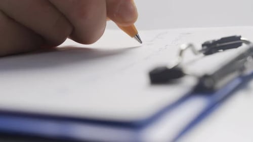 Writing notes with a close-up pen.