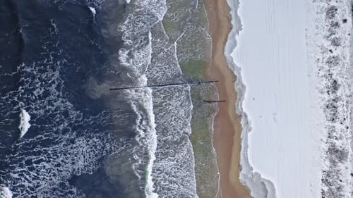 Winter tourism, Poland. Aerial view. Snowy beach at Baltic sea.