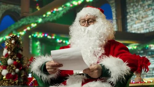 Santa Claus Reading Letters From Kids Adorning Workshop with Xmas Ornaments