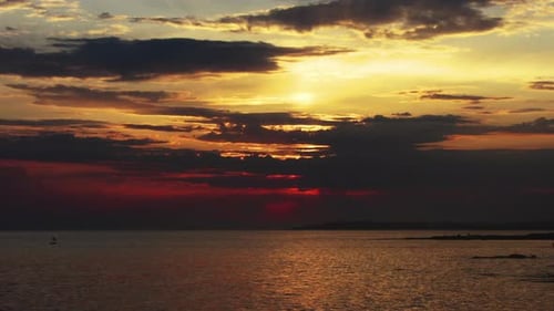 Sunset Sun and Clouds Over Sea