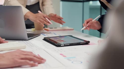 Professionals Collaborating on Data Analysis in Modern Office