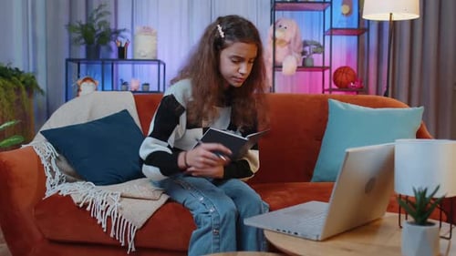 Girl Studying With Laptop and Notebook at Home
