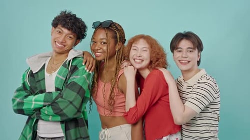 Group of Friends Posing in Front of Blue Background