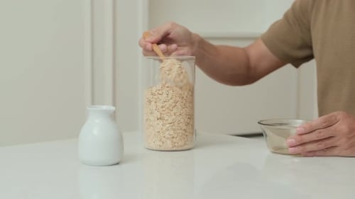 Man Prepares Oatmeal in Bright Home Kitchen