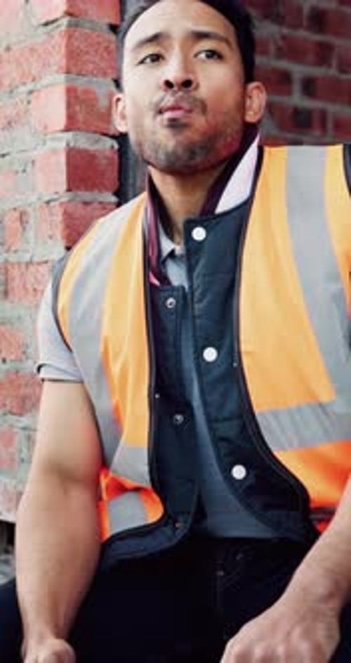 Worker, man and eating at construction site with break, fruit and thinking for building renovation