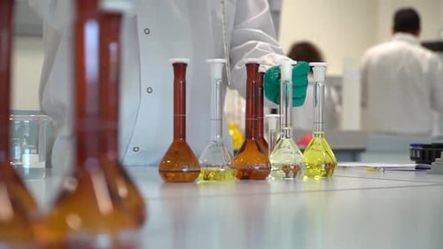Dolly shot Scientist fill test tube with liquid, Laboratory environment