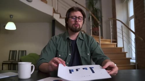 Young Businessman or Coach Speaking in Front of Device and Sitting at Table in Home Office Spbas