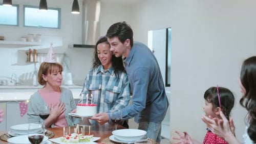 Family Celebrates Birthday with Cake and Applause