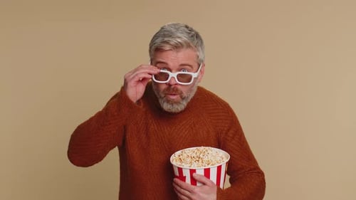Adult Eats Popcorn Wearing 3D Glasses