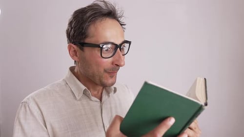 Man Reading a Book is Surprised