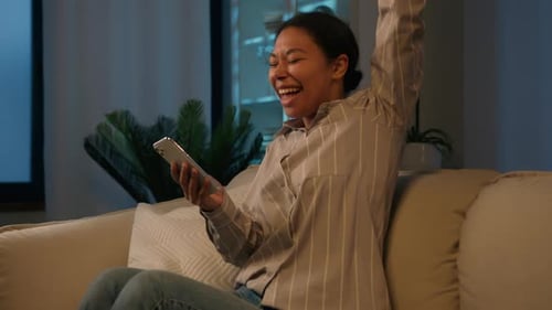 Woman Reacting to Phone with Joyful Elation