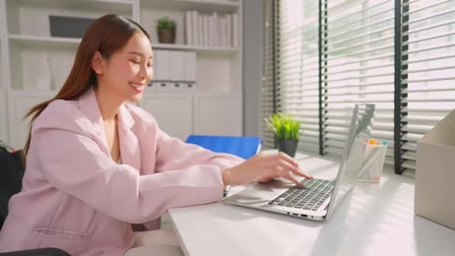 Asian young businesswoman in wheelchair working in the office workplace.