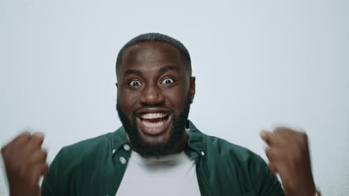Excited Man Celebrates Success with Fists Raised