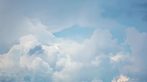 Fluffy White Clouds Against a Blue Sky
