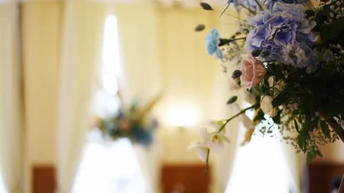 Wedding Decor Flower Bouquets and Compositions in Restaurant Hall with Blue White Roses Petals