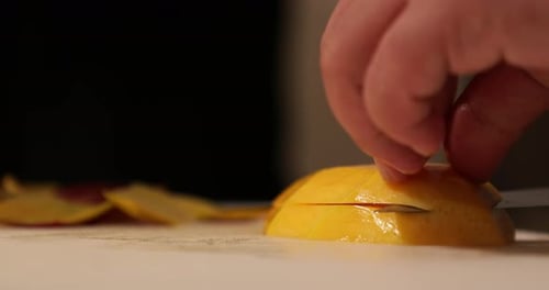 Mango Slicing on White Cutting Board