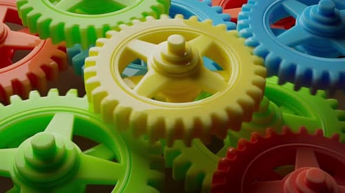 Looping 3D animation multi-colored plastic toy gears.