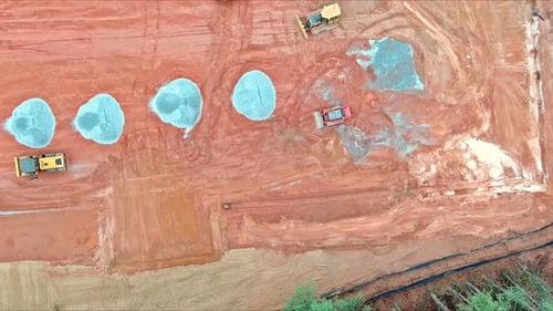 An Aerial View of a Construction Site with Tractors Bulldozers Workers Shaping Land During